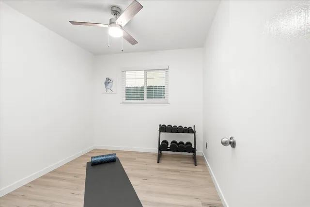 a bedroom with a bed and flat tv screen on the dresser