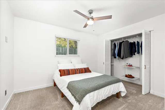 a bedroom with a large bed and a chandelier