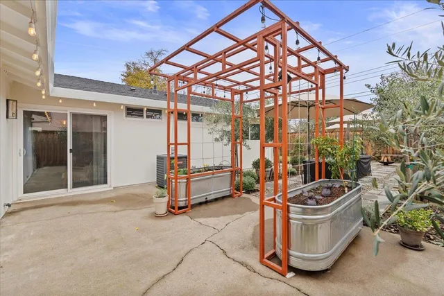 a view of a patio with a table and chairs under an umbrella