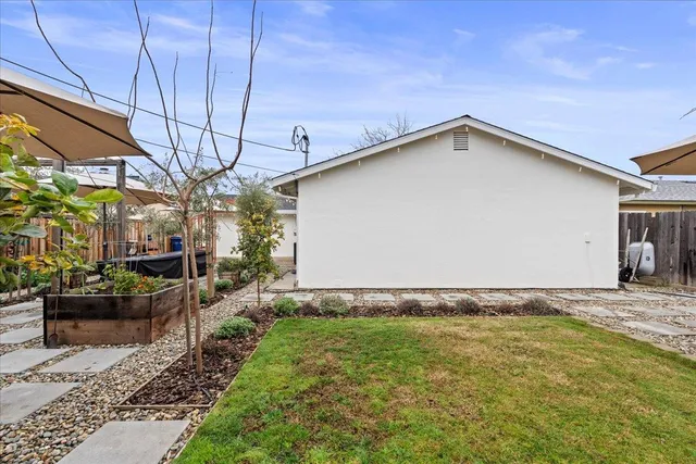 a view of a patio with a table and chairs under an umbrella