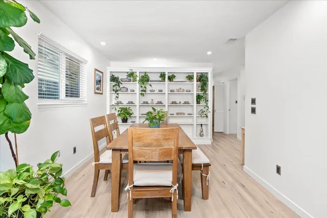 a view of a dining room with furniture and a potted plant