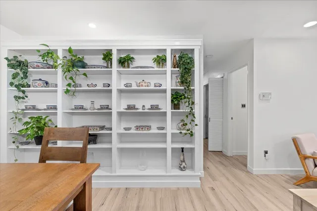 a view of a workspace with furniture and wooden floor