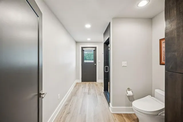 a bathroom with a toilet and a shower