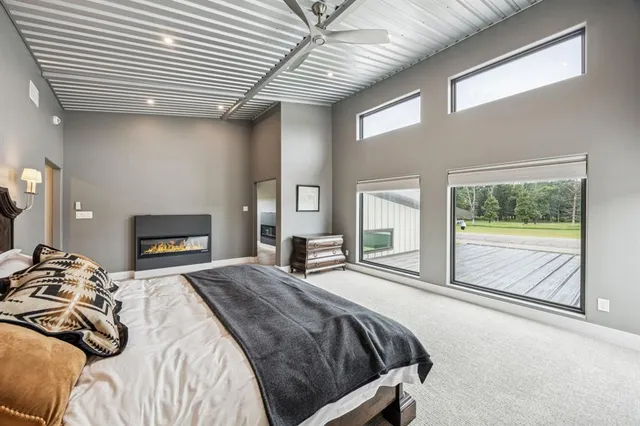 a spacious bedroom with a bed and a fireplace