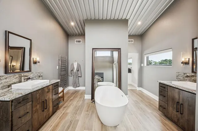 a spacious bathroom with a granite countertop sink and mirror