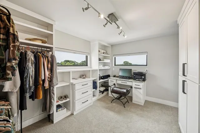 a view of walk in closet with clothes