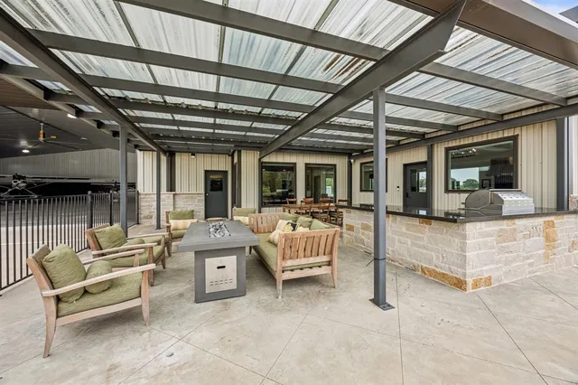 a view of a patio with a table and chairs