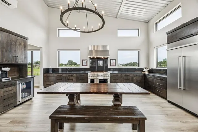 a kitchen with stainless steel appliances granite countertop a lot of counter space cabinets and wooden floor