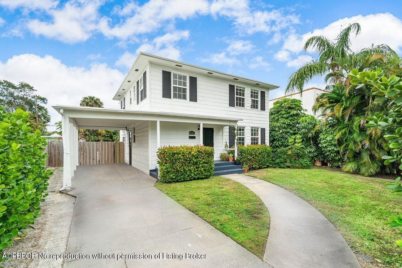 231 Argyle Road West Palm Beach, FL 33405 - Photo 1 of 17 a front view of a house with a yard and potted plants