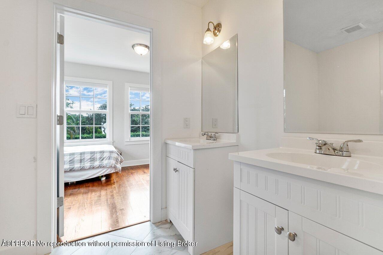 231 Argyle Road West Palm Beach, FL 33405 - Photo 11 of 17 a en suite bathroom with a sink double vanity and a mirror