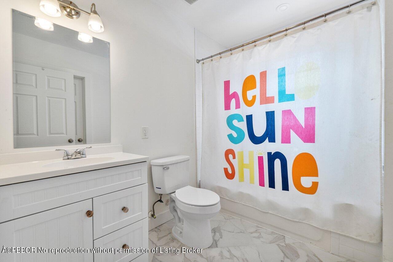 231 Argyle Road West Palm Beach, FL 33405 - Photo 13 of 17 a bathroom with a sink a vanity and toilet