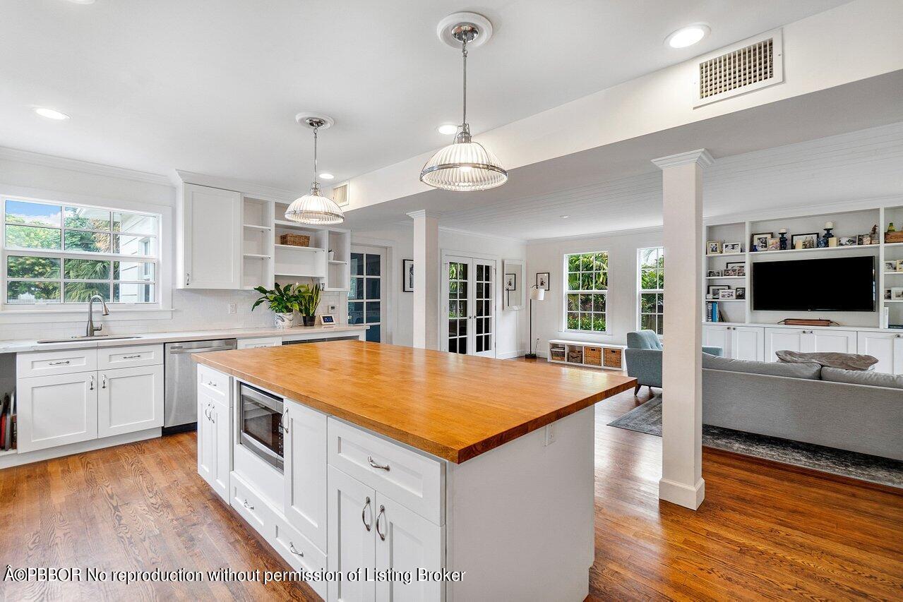231 Argyle Road West Palm Beach, FL 33405 - Photo 3 of 17 a kitchen with stainless steel appliances granite countertop a sink dishwasher and a stove with wooden floor