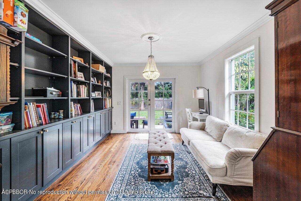 231 Argyle Road West Palm Beach, FL 33405 - Photo 6 of 17 a living room with furniture lots of books and a large window