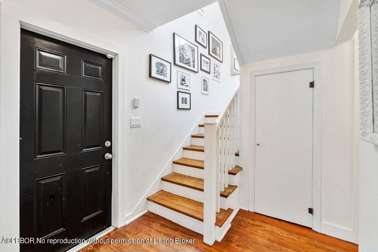 231 Argyle Road West Palm Beach, FL 33405 - Photo 8 of 17 a view of entryway with stairs and wooden floor