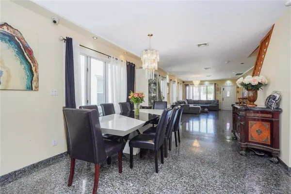 a kitchen with stainless steel appliances granite countertop a refrigerator a stove and a refrigerator
