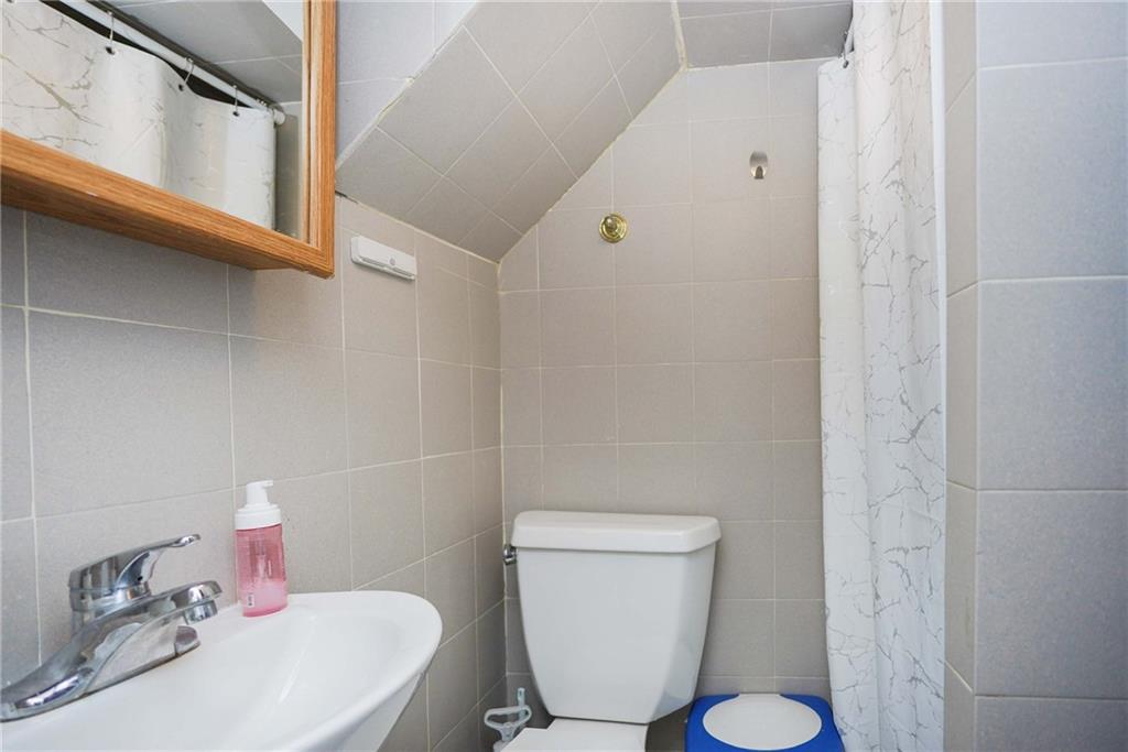 1730 East 4th Street Brooklyn, NY 11223 - Photo 15 of 24 a white toilet sitting next to a bathroom sink