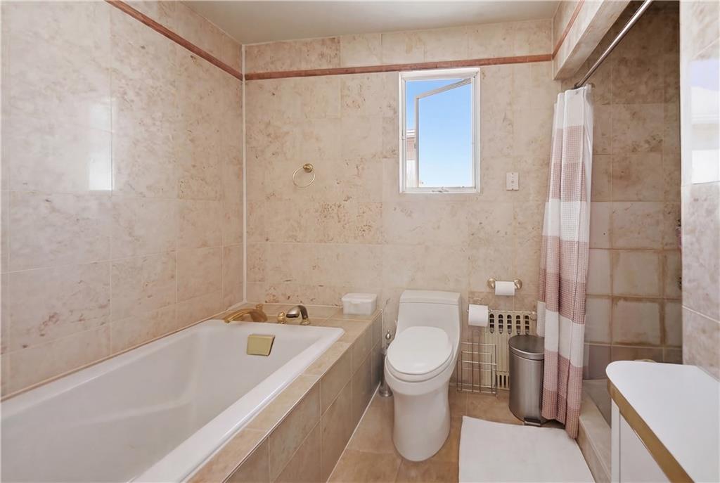 1730 East 4th Street Brooklyn, NY 11223 - Photo 17 of 24 a bathroom with a toilet and a bathtub