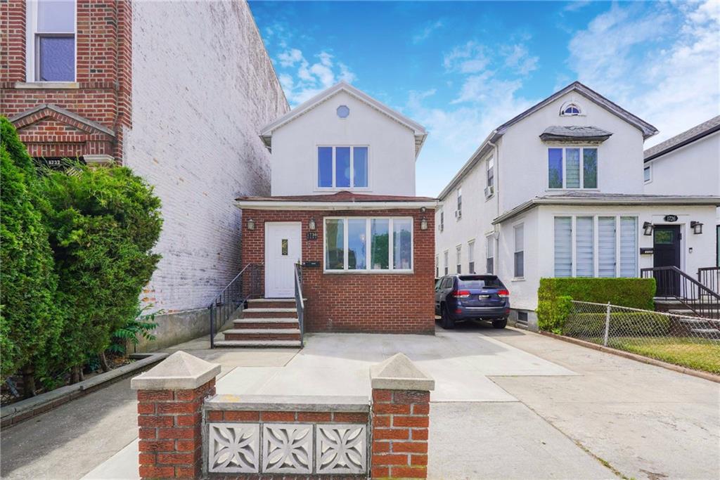 1730 East 4th Street Brooklyn, NY 11223 - Photo 3 of 24 a front view of a house with a garden