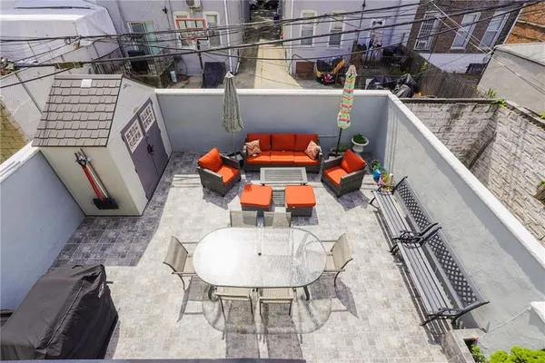 a balcony with table and chairs