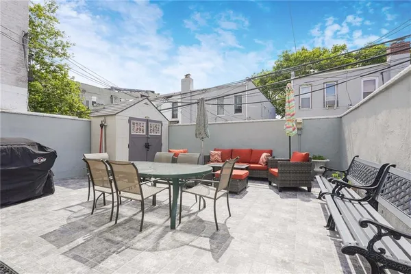 a backyard of a house with table and chairs
