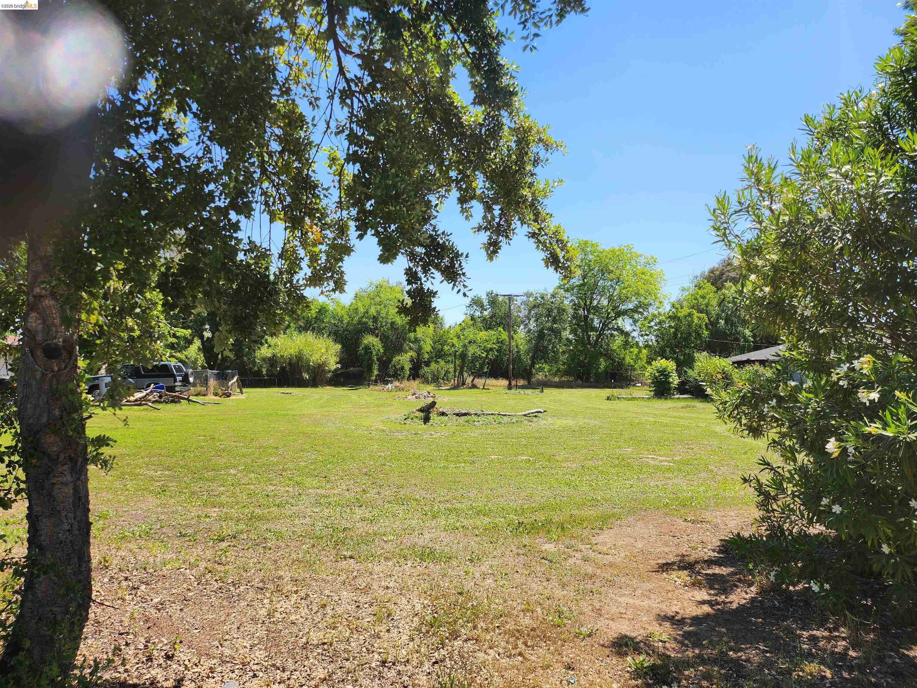 7750 Locke Road Vacaville, CA 95688 - Photo 15 of 23 Expansive green space featuring mature trees and established perimeter landscaping