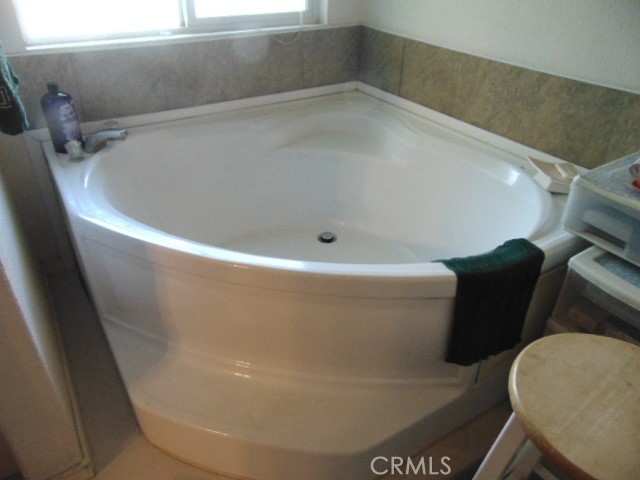 3835 Gardiner Ferry Road, Unit 62 Corning, CA 96021 - Photo 28 of 34 a white bath tub sitting in a bathroom