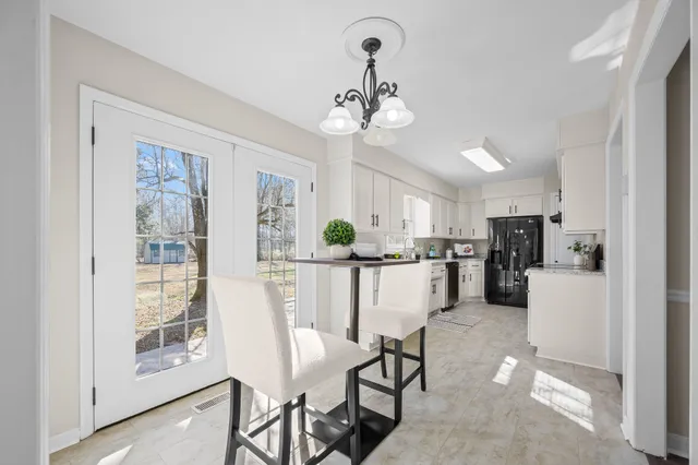a bathroom with a granite countertop sink mirror vanity and toilet