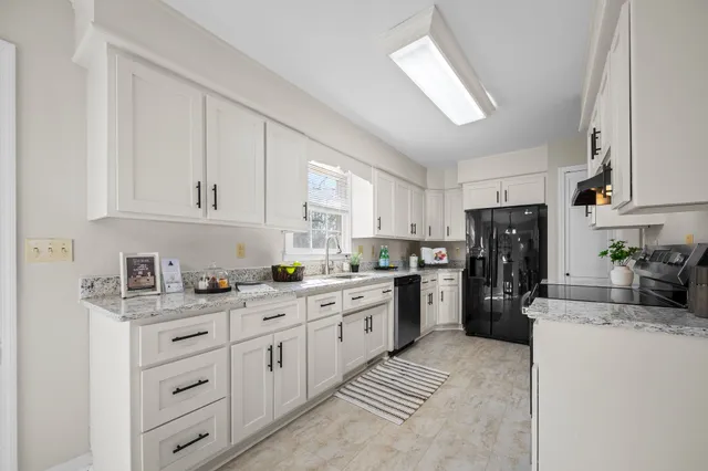 a bedroom with a bed next to a window with a dresser