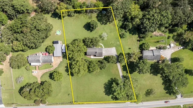 a living room with furniture a fireplace with a flat screen tv