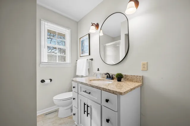 an aerial view of residential houses with outdoor space and trees
