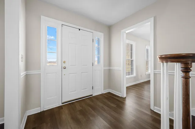 a living room with fireplace furniture and a wooden floor