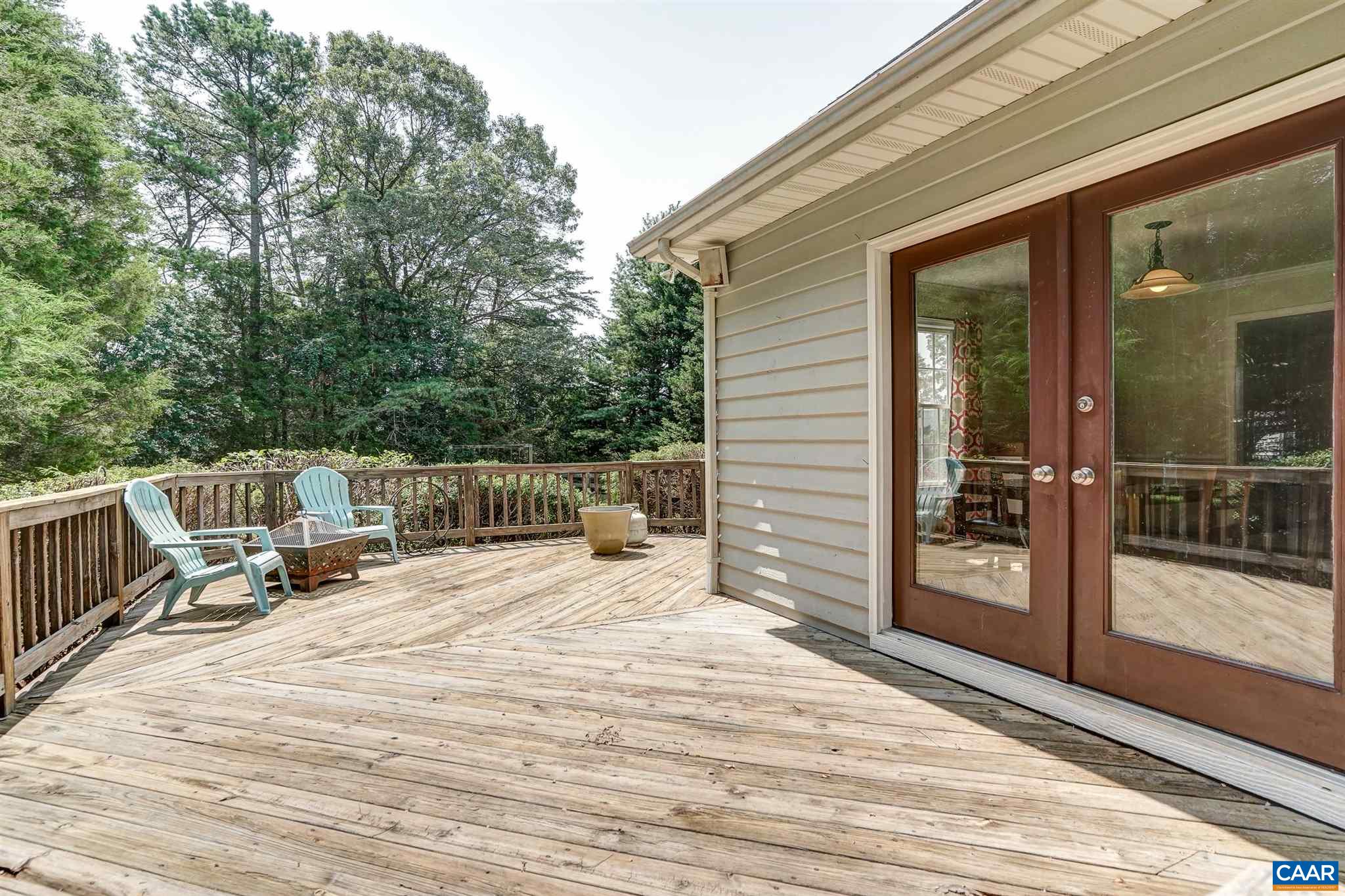 152 Spring Oaks Lane Ruckersville, VA 22968 - Photo 13 of 34 a roof deck with a table and chairs and wooden floor
