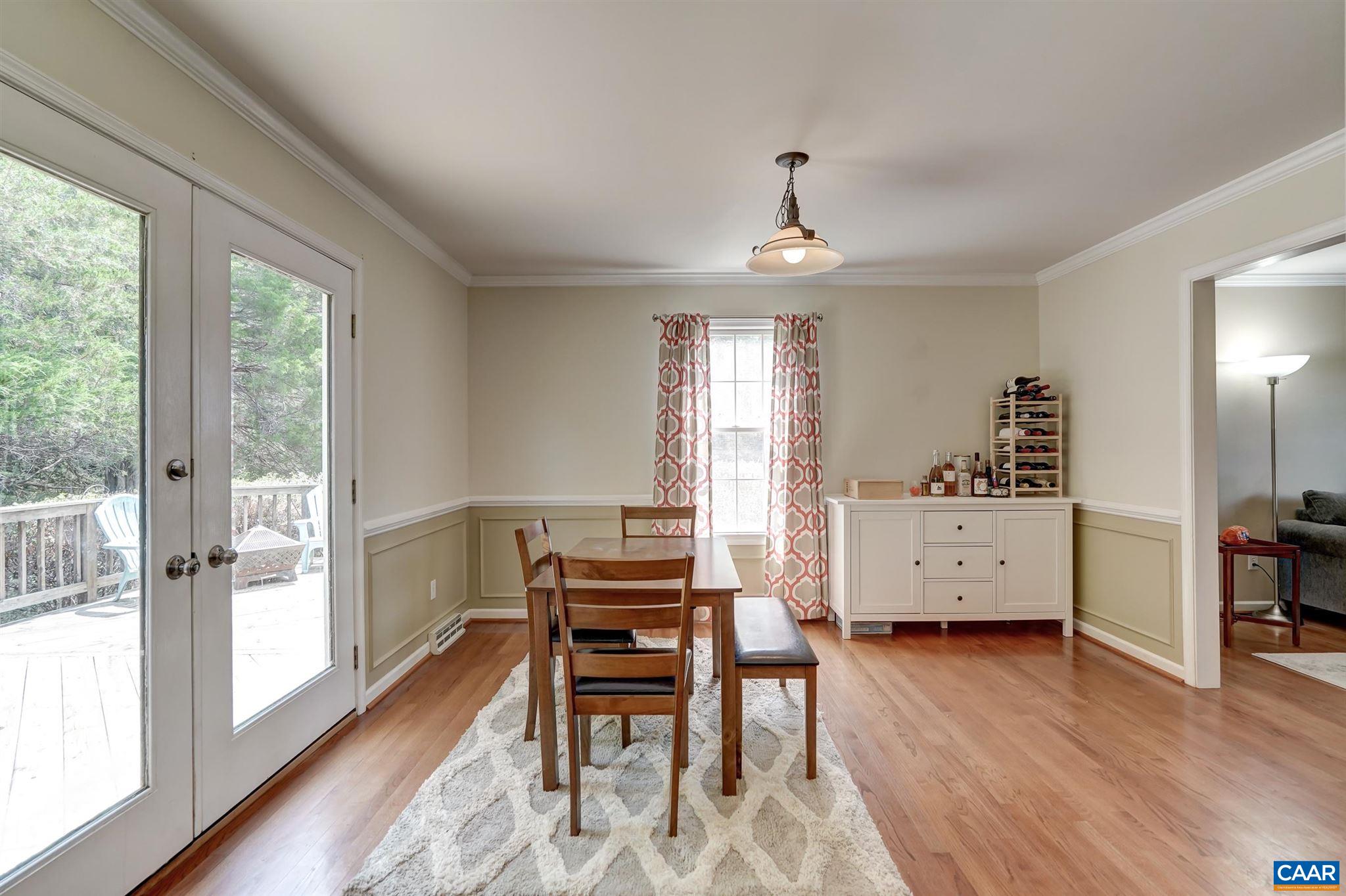152 Spring Oaks Lane Ruckersville, VA 22968 - Photo 21 of 34 a view of a dining room with furniture and wooden floor