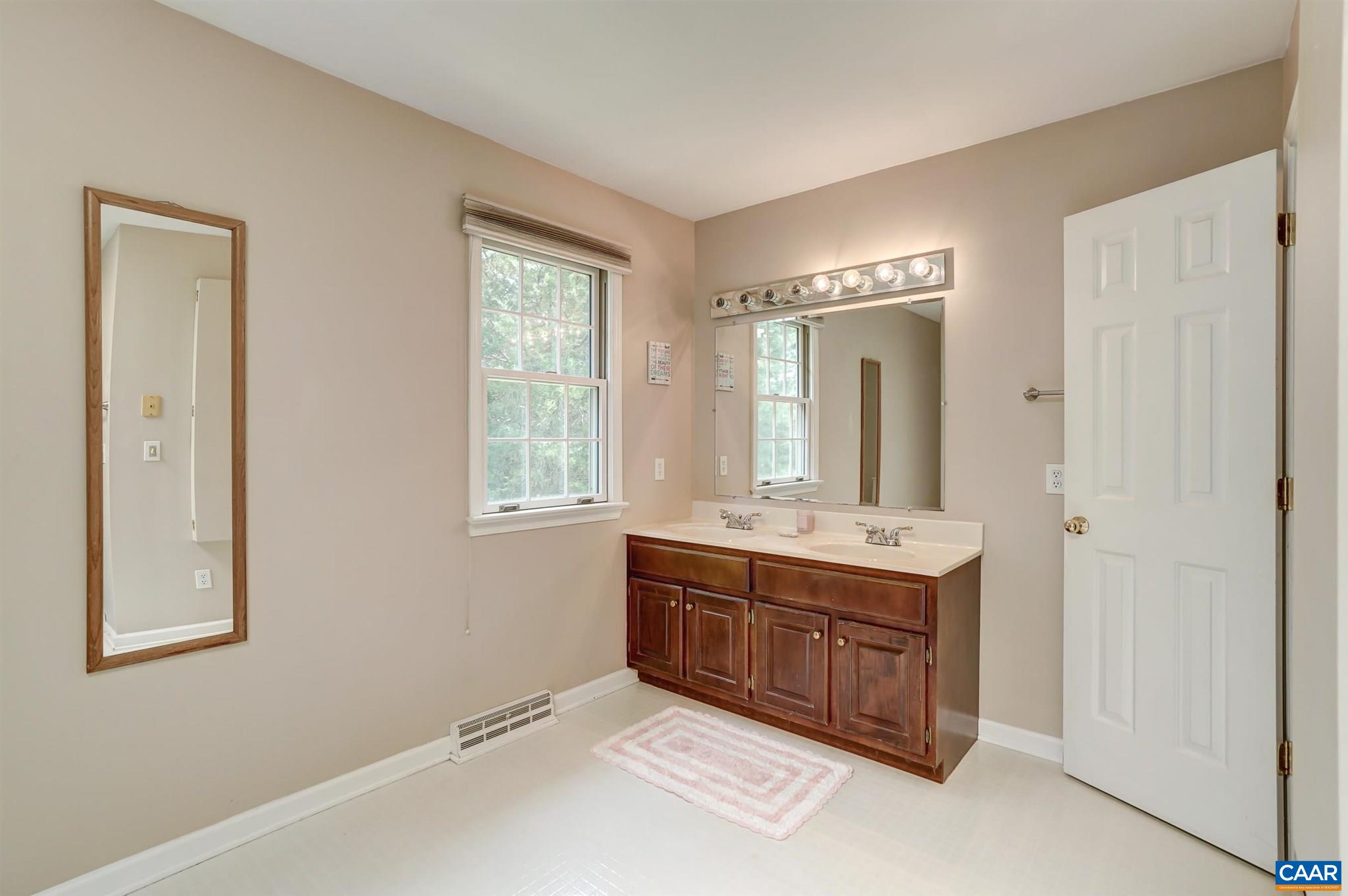 152 Spring Oaks Lane Ruckersville, VA 22968 - Photo 31 of 34 a spacious bathroom with a double vanity sink and a mirror