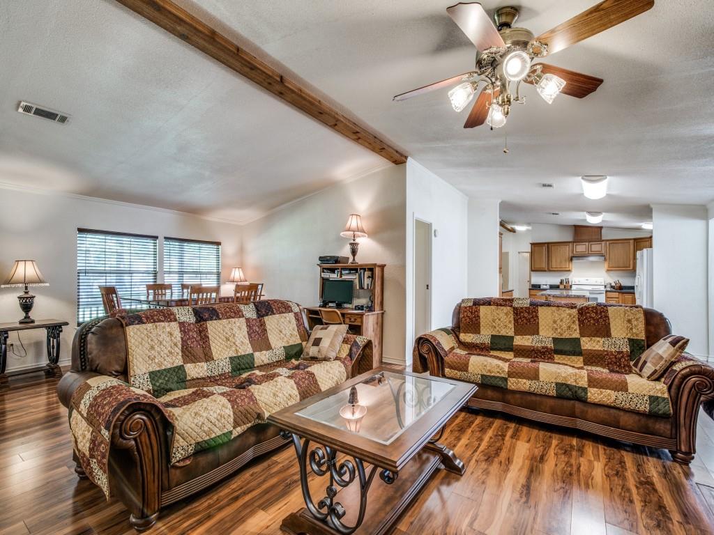 233 Esquire Estates Road Mabank, TX 75156 - Photo 6 of 34 Living room with wood finished floors, ceiling fan, and a textured ceiling