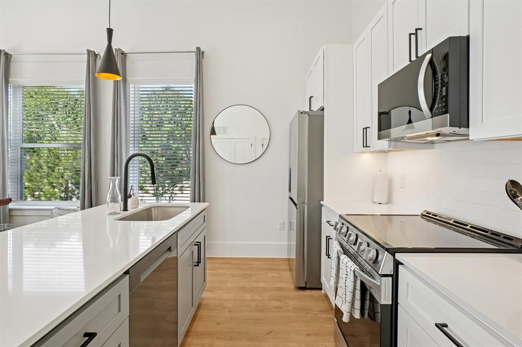 6418 Maple Avenue, Unit 307 Dallas, TX 75235 - Photo 4 of 16 a kitchen with stainless steel appliances granite countertop a sink and a stove