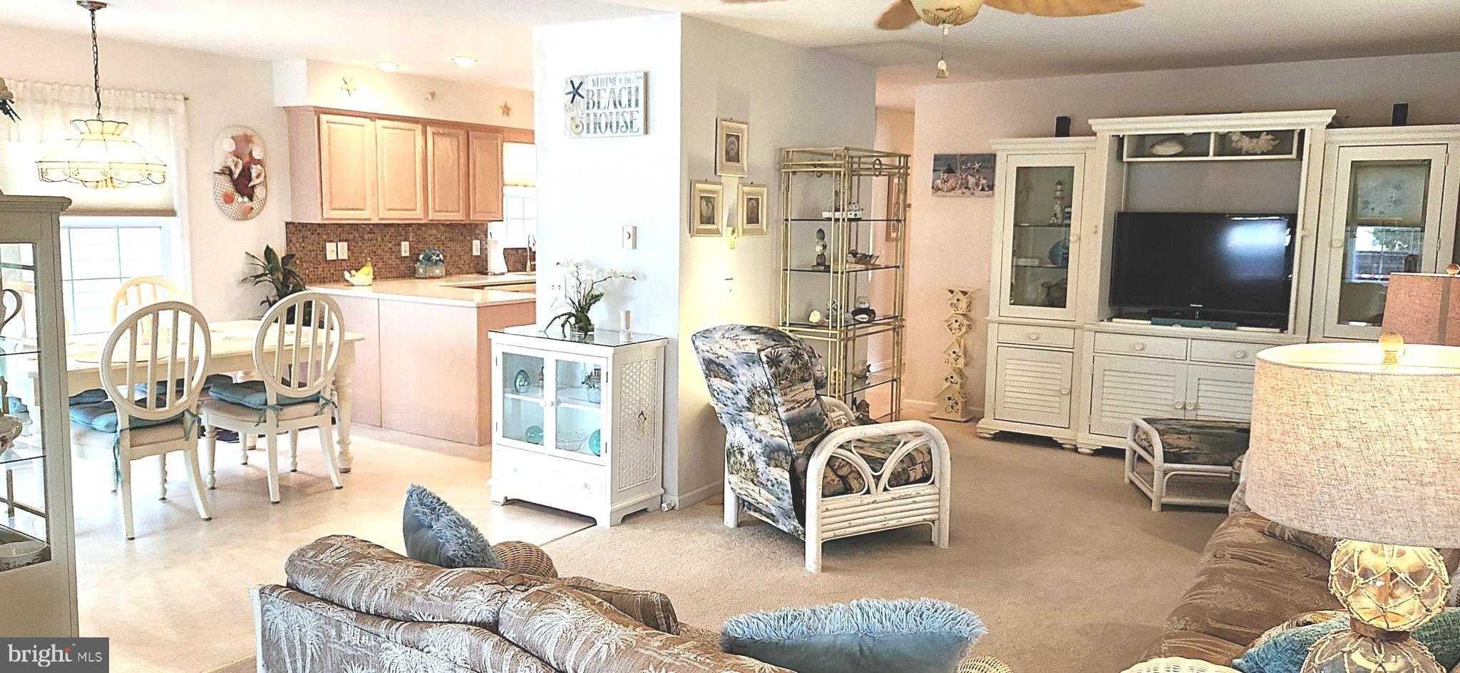 13322 Peachtree Road Ocean City, MD 21842 - Photo 11 of 54 a living room with furniture a flat screen tv and kitchen view