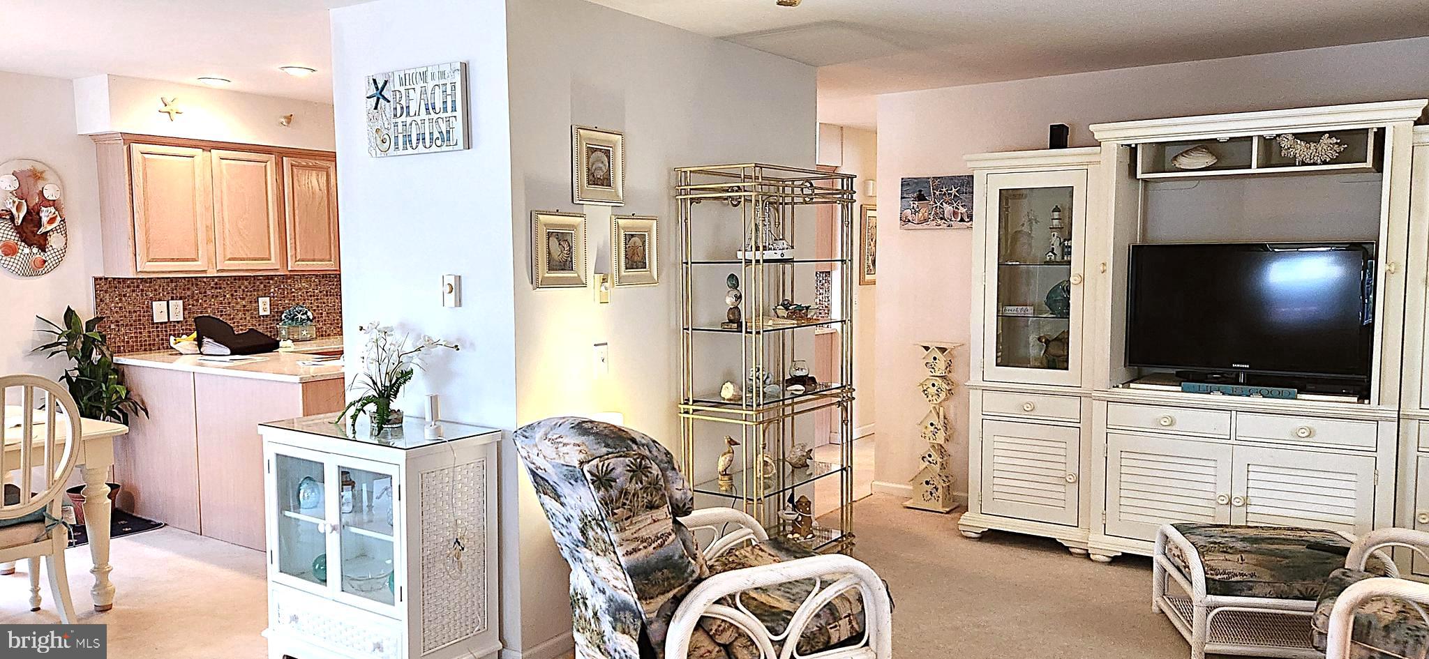 13322 Peachtree Road Ocean City, MD 21842 - Photo 12 of 54 a living room with furniture and a flat screen tv