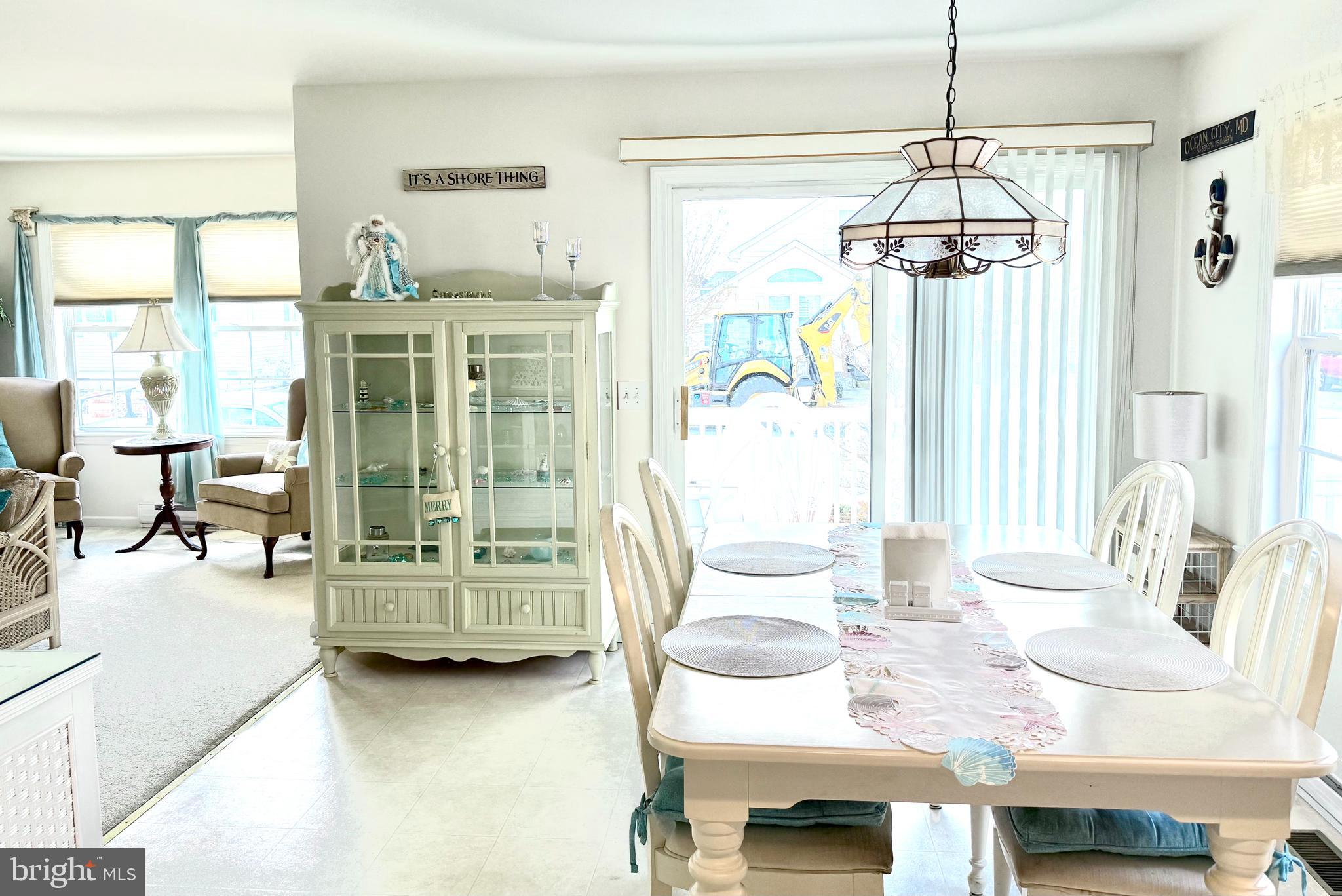 13322 Peachtree Road Ocean City, MD 21842 - Photo 18 of 54 a dining room with furniture a chandelier and glass door