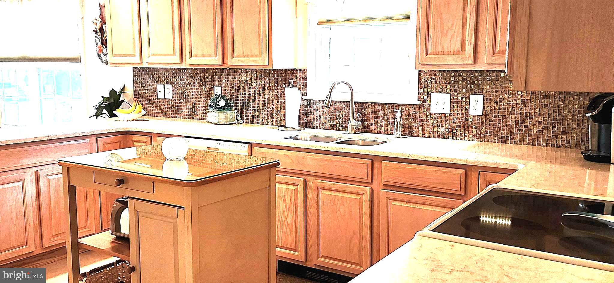 13322 Peachtree Road Ocean City, MD 21842 - Photo 21 of 54 a kitchen with granite countertop a sink a stove and cabinets