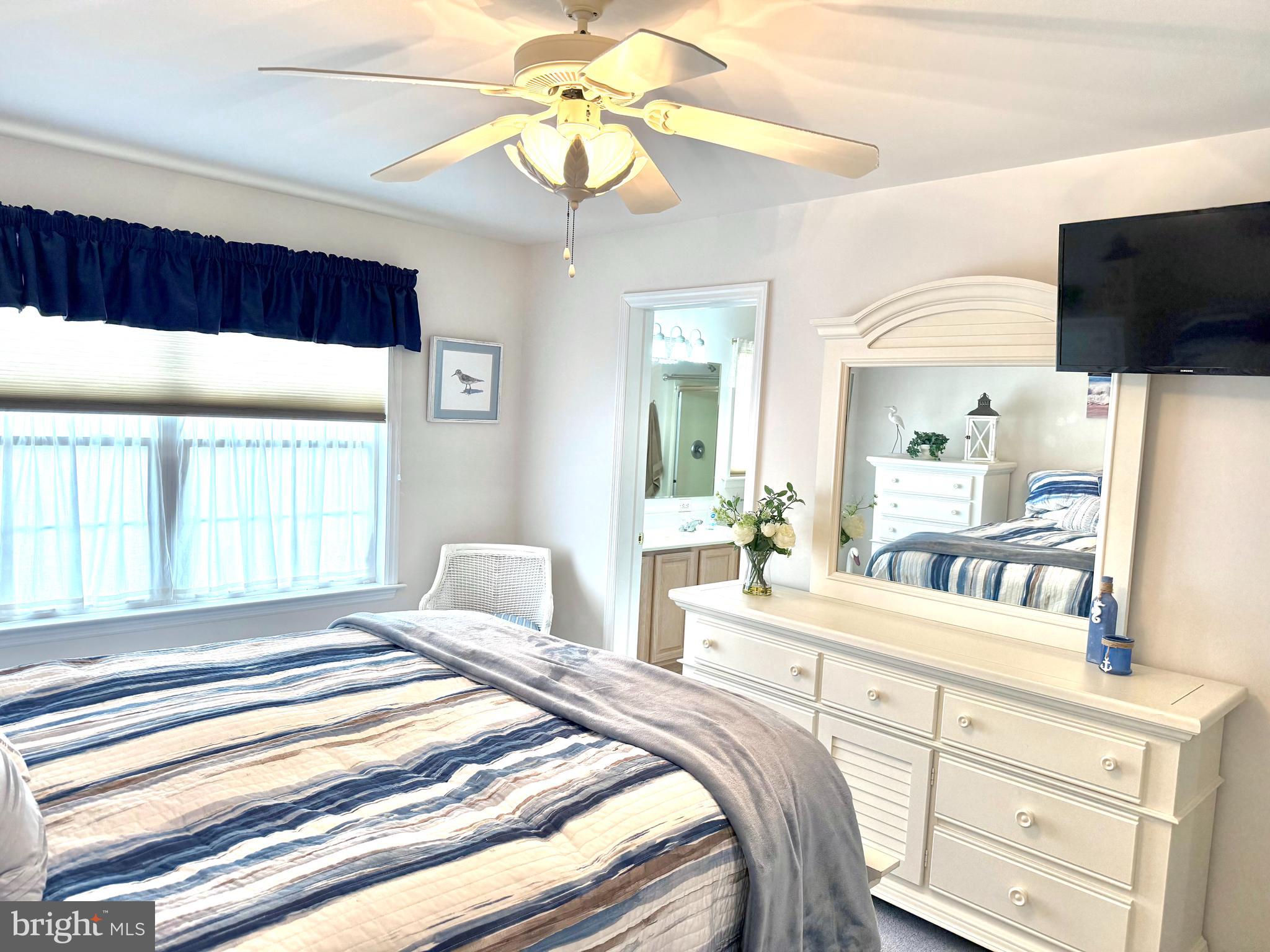 13322 Peachtree Road Ocean City, MD 21842 - Photo 25 of 54 a bedroom with a bed a window and a flat screen television