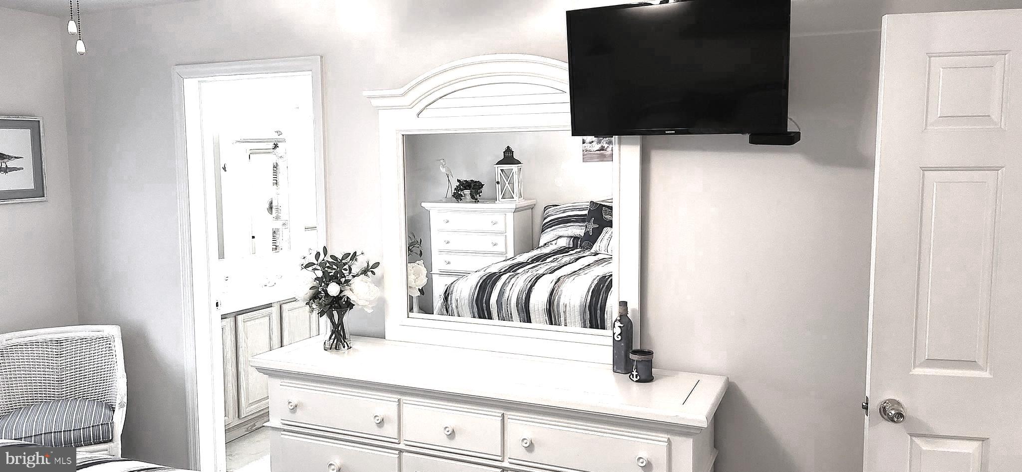 13322 Peachtree Road Ocean City, MD 21842 - Photo 26 of 54 a living room with furniture and a flat screen tv