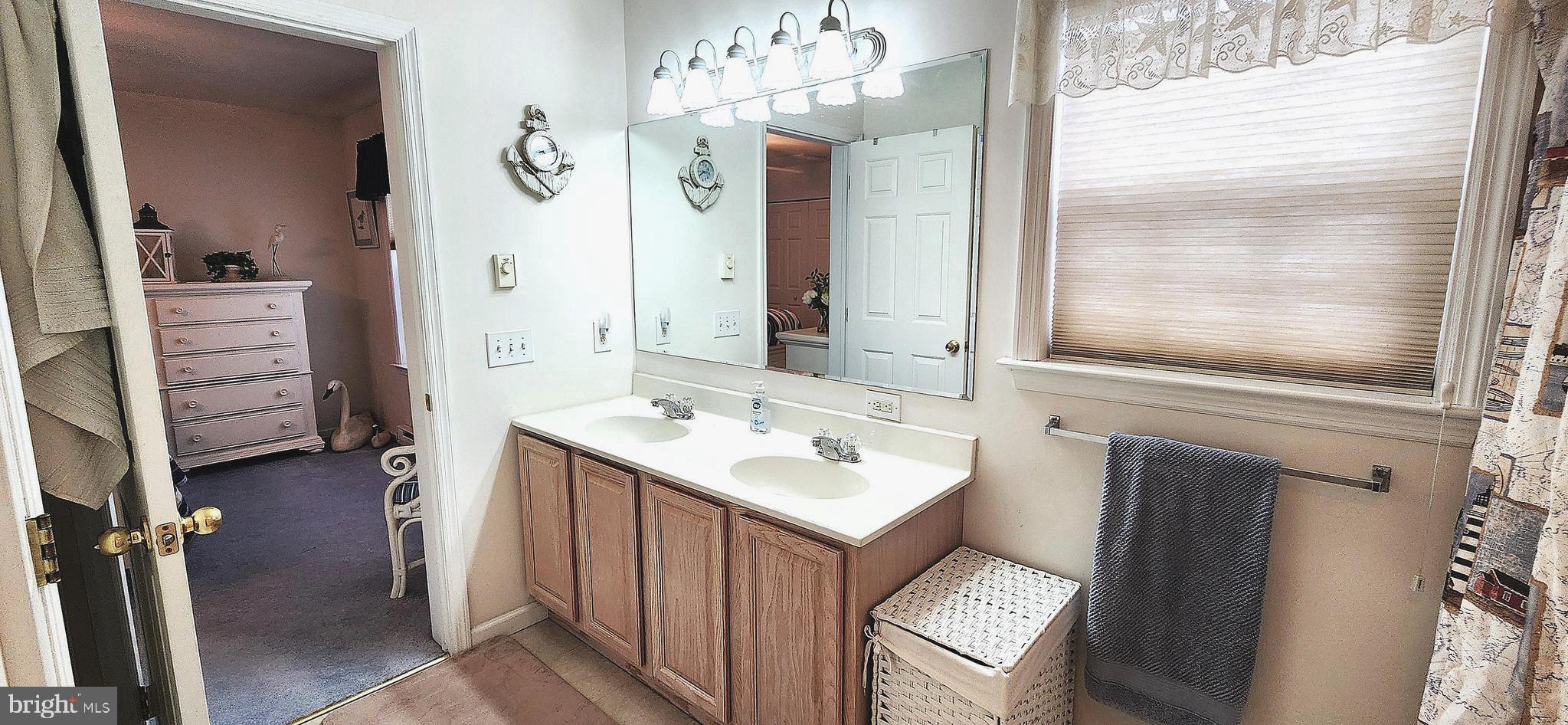 13322 Peachtree Road Ocean City, MD 21842 - Photo 28 of 54 a bathroom with a sink a mirror and a shower