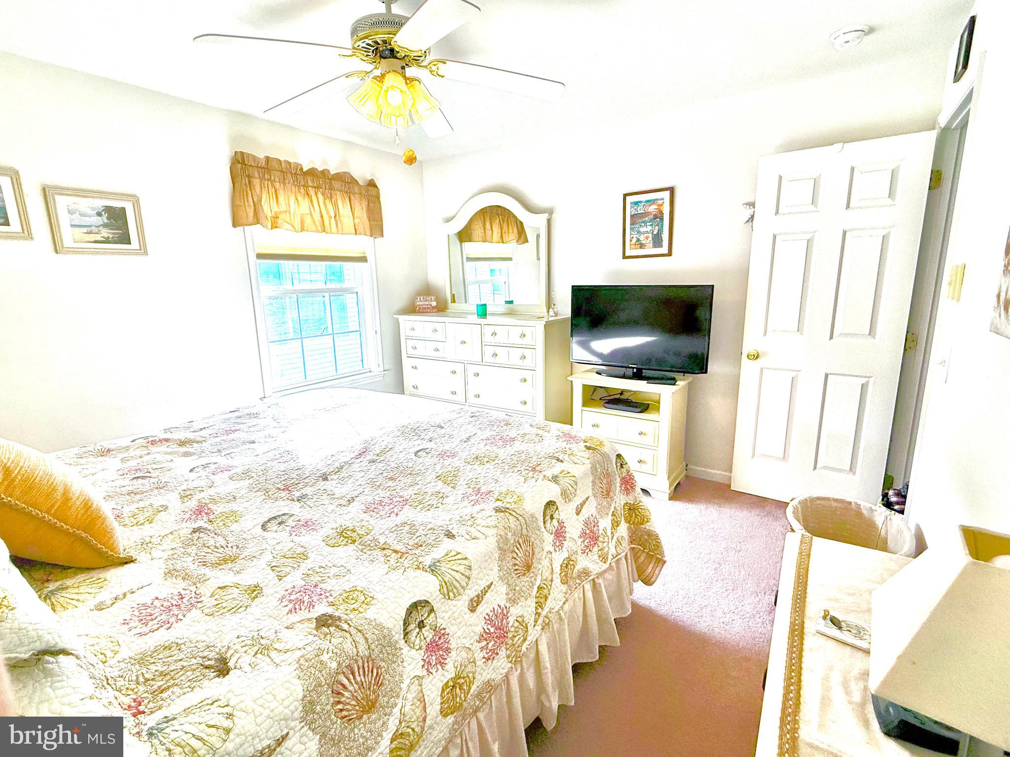 13322 Peachtree Road Ocean City, MD 21842 - Photo 30 of 54 a bedroom with a bed and a flat screen tv