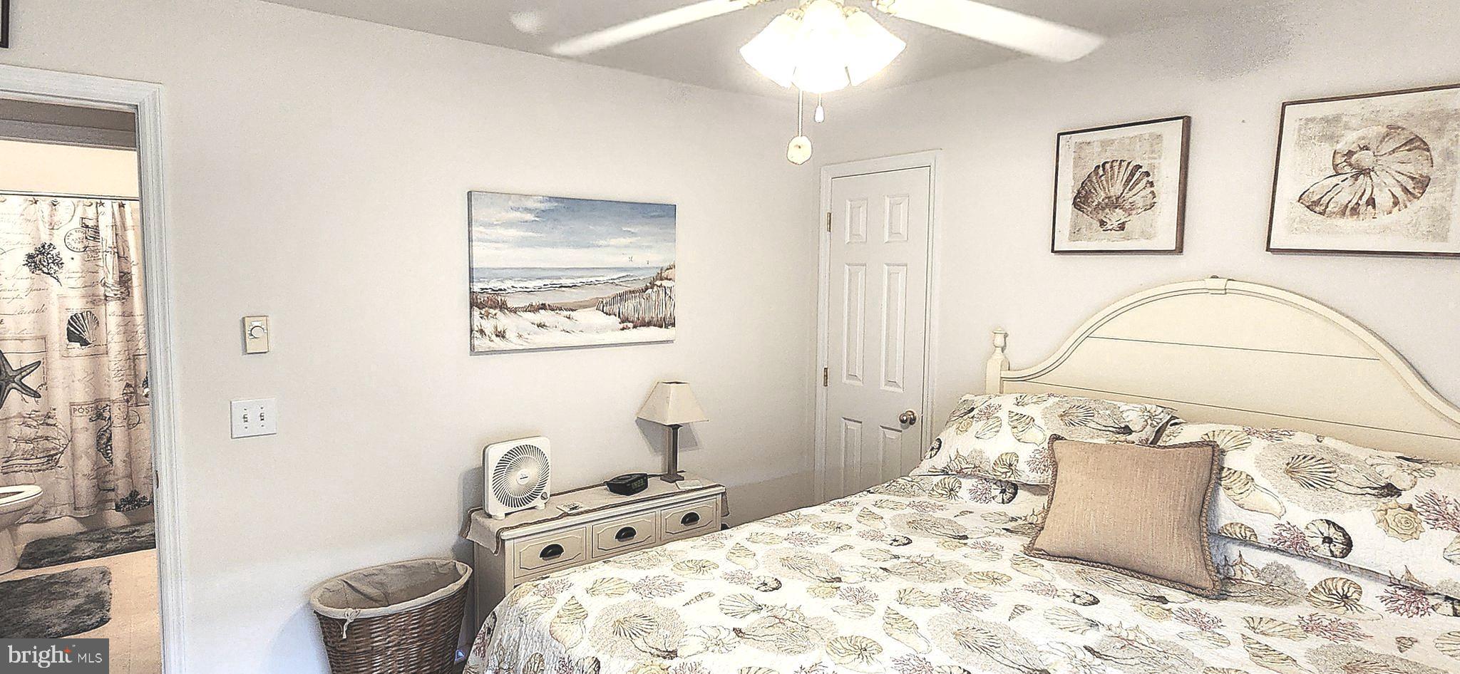 13322 Peachtree Road Ocean City, MD 21842 - Photo 31 of 54 a bedroom with a bed and a painting on the wall