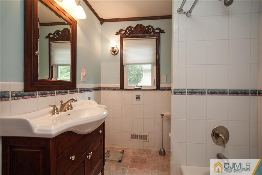 91 George Avenue Edison, NJ 08820 - Photo 12 of 21 a bathroom with a sink and a mirror