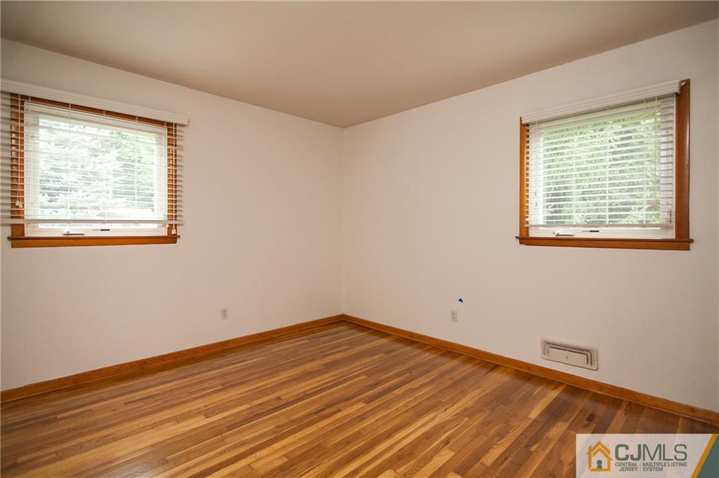 91 George Avenue Edison, NJ 08820 - Photo 13 of 21 a view of empty room with wooden floor and fan