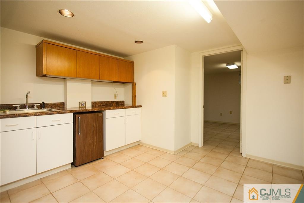 91 George Avenue Edison, NJ 08820 - Photo 18 of 21 a kitchen with a sink cabinets and a stove top oven