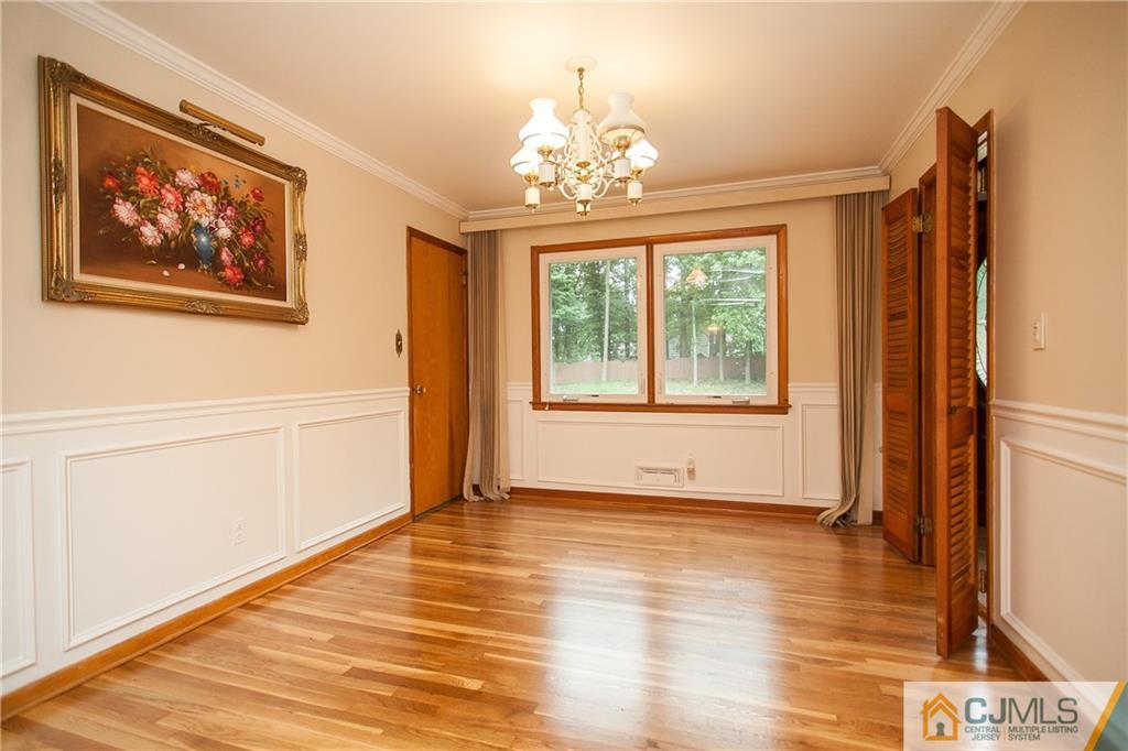 91 George Avenue Edison, NJ 08820 - Photo 8 of 21 a view of an empty room with wooden floor and a window