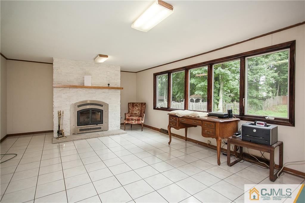91 George Avenue Edison, NJ 08820 - Photo 9 of 21 a living room with furniture and a fireplace